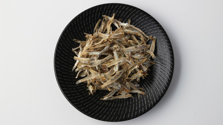anchovies on black plate
