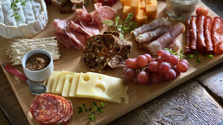 Charcuterie board with sliced meats