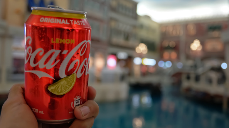 A can of Coca-Cola Lemon with the canals of Venice in the background.
