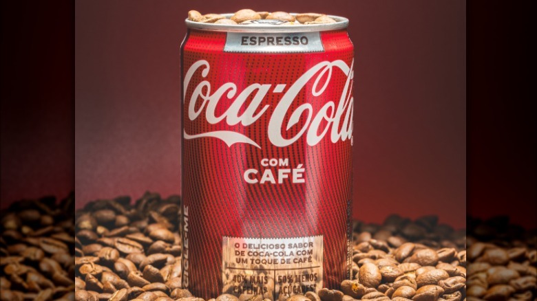 A can of Coca-Cola Plus Café Espresso sitting in espresso beans.