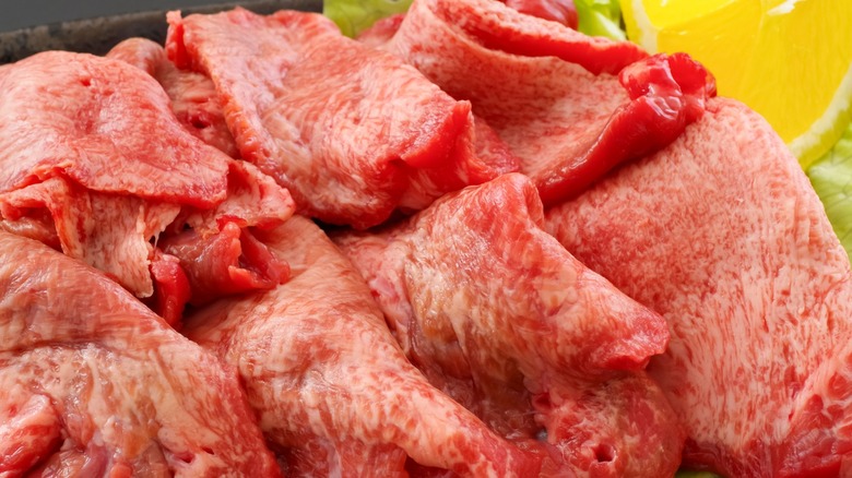 Slices of raw beef tongue