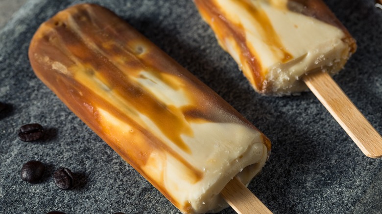 Two white and brown popsicles