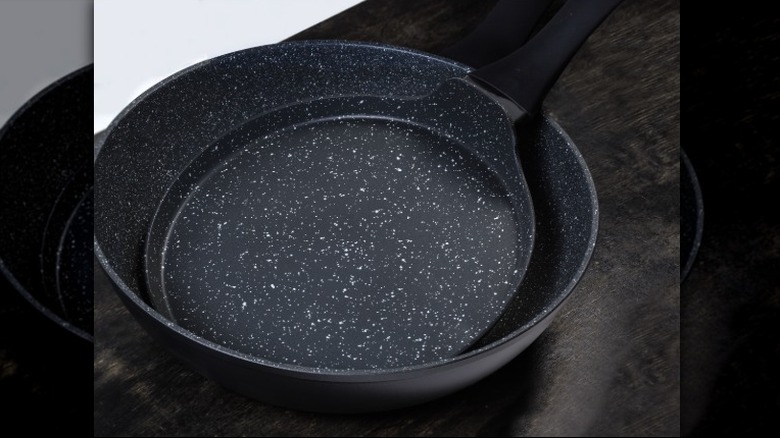 Two empty frying pans stacked in each other