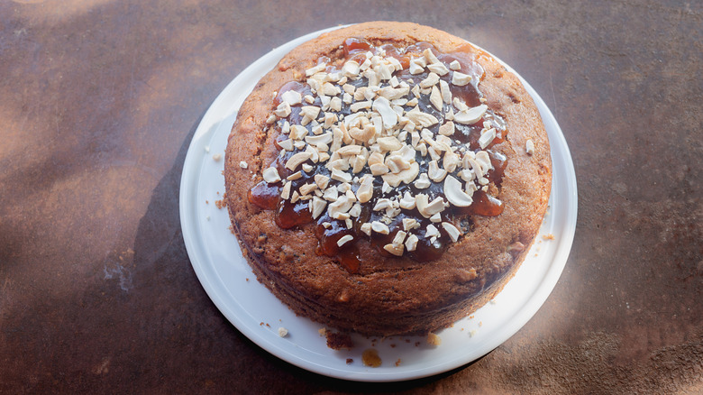 Olive oil cake, decorated with apricot jam and cashew nuts