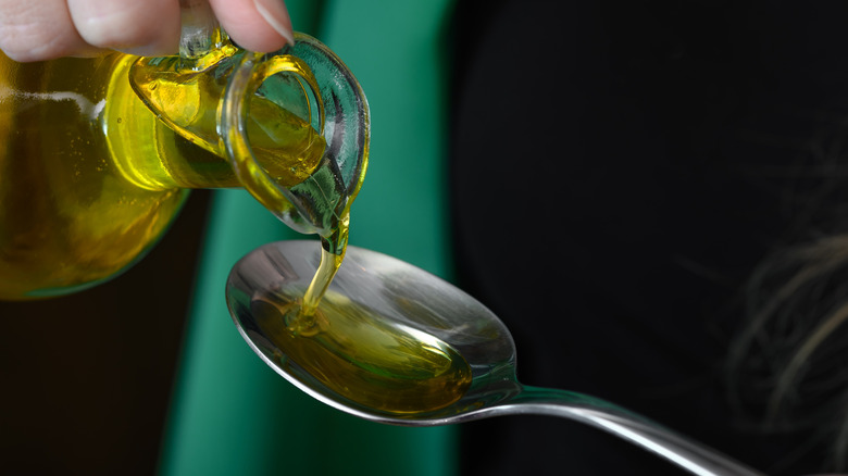 Oil being poured into spoon