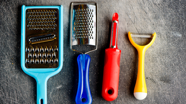 Peelers and graters on counter