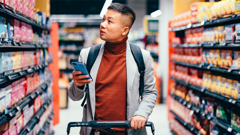 man pushing grocery cart
