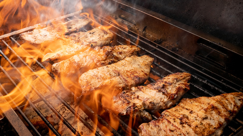 chicken breasts cooking on fire
