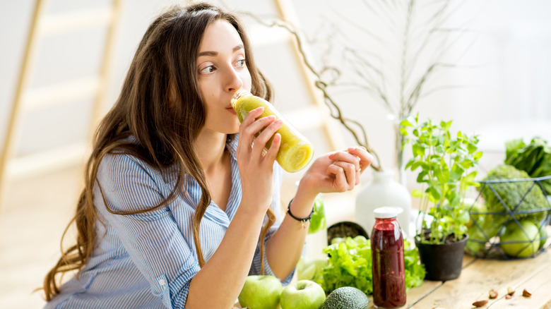 Woman drinking green juice
