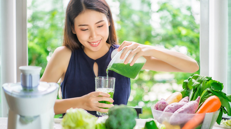 Woman with cold pressed juice 