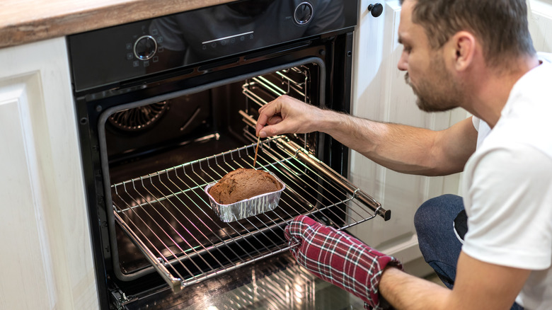 Person checking baked good doneness