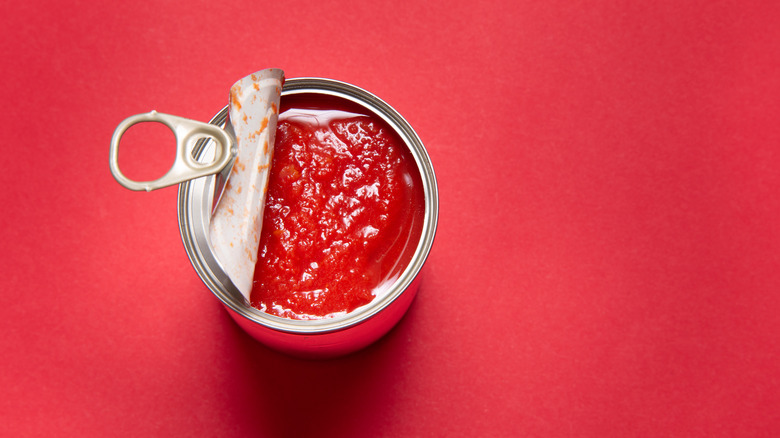 tomato sauce can against red
