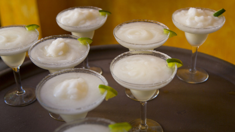 Seven frozen margaritas on a tray
