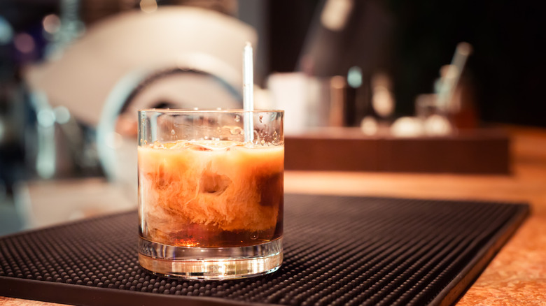 A White Russian cocktail on a bar mat