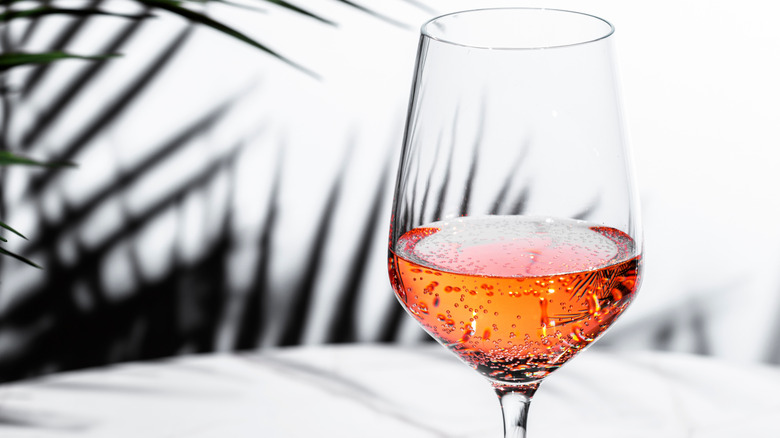 Close-up of sparkling pink wine in a glass