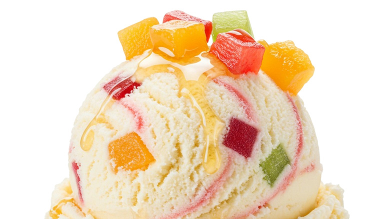 A close-up scoop of tutti frutti ice cream with cubes of colorful fruit