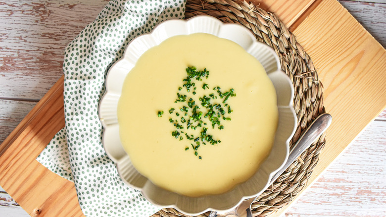a white bowl of vichyssoise styled on a rustic table