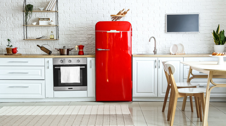 modern white kitchen with red retro fridge