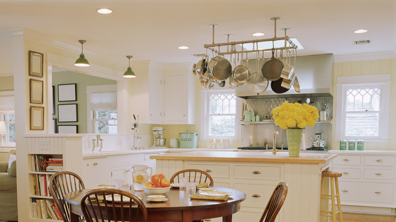 stylish kitchen with overhead pot rack, hanging pots and pans from ceiling