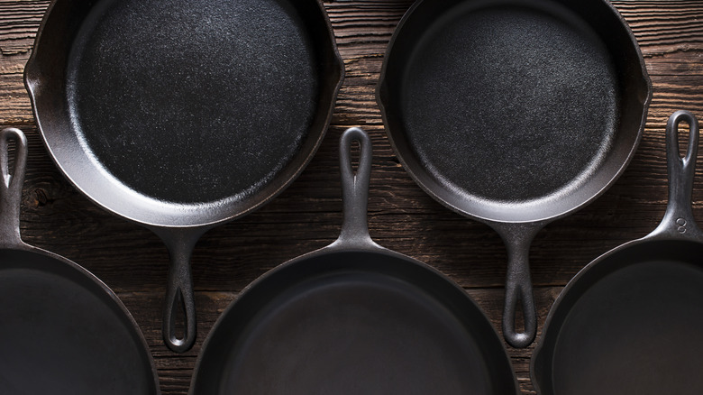 cast iron pans shot overhead on a wood backdrop