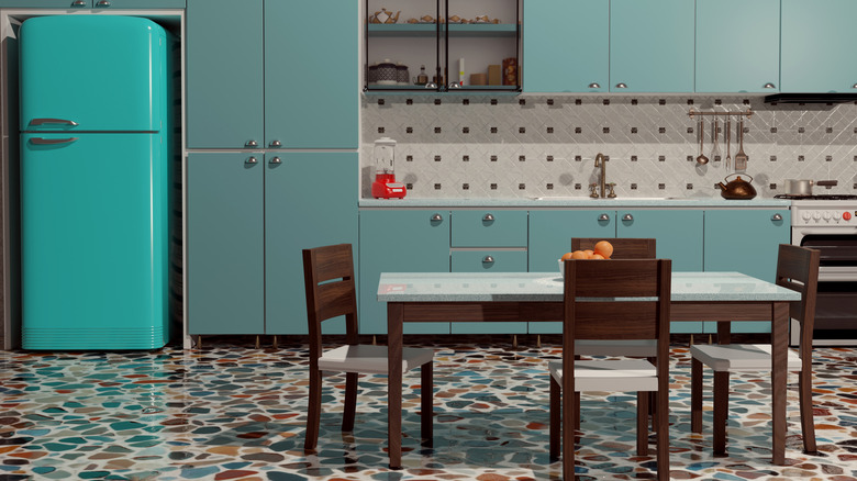 retro kitchen with blue fridge and cabinets, freestanding dining table