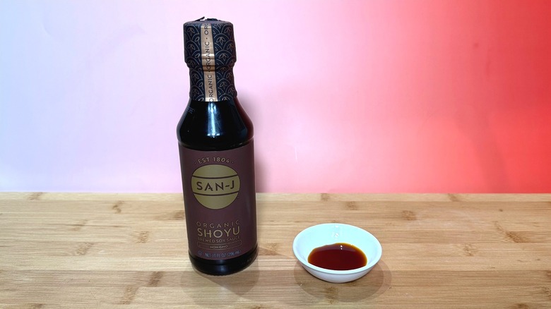 Bottle and small bowl of San-J soy sauce