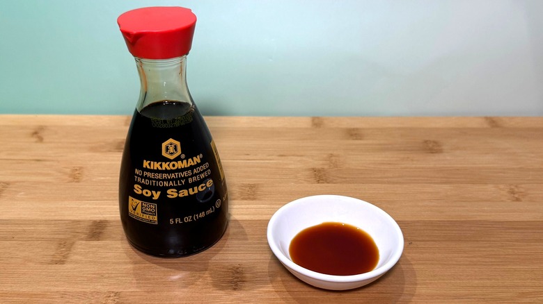 Bottle and small bowl of Kikkoman soy sauce