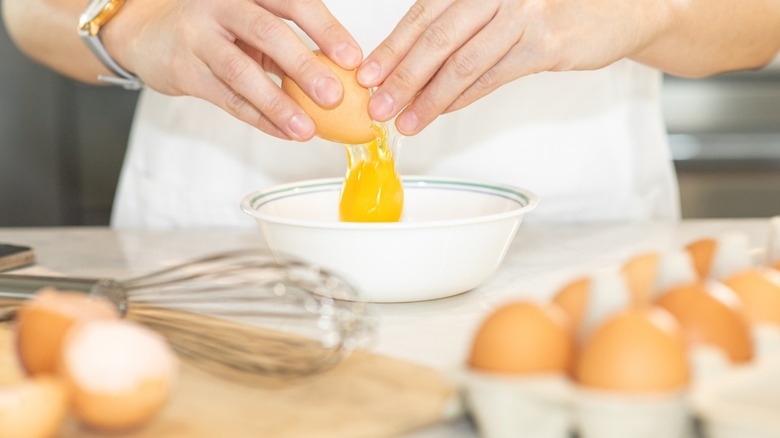 Cracking egg into a bowl