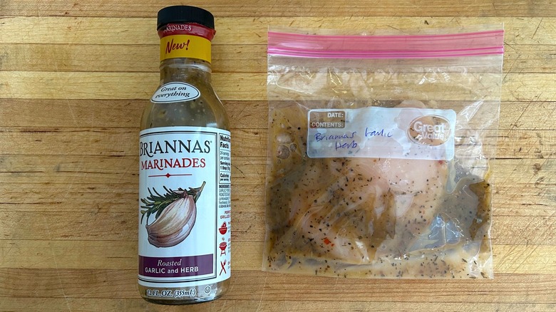 Bottle of Briannas Marinades Roasted Garlic & Herb and bag with chicken marinating