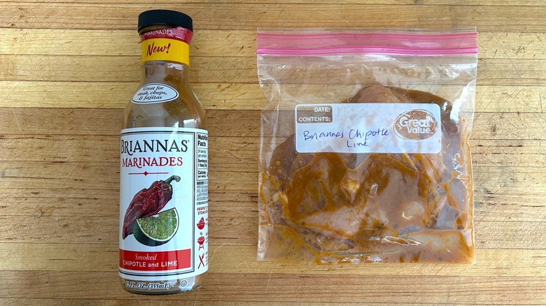 Bottle of Briannas Marinades Smoked Chipotle and Lime and bag with chicken marinating