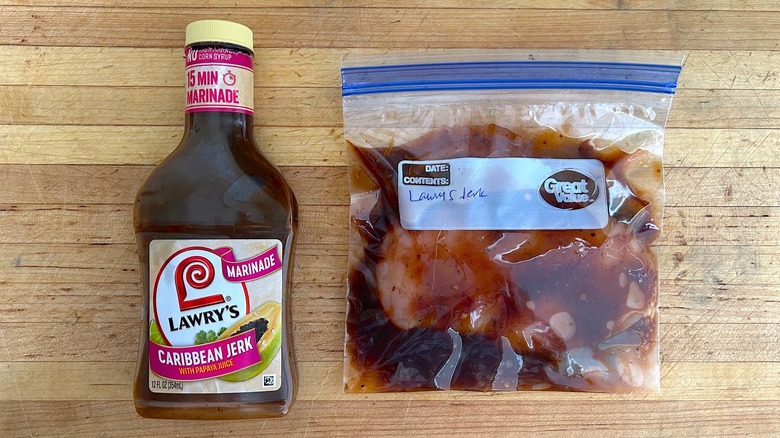 Bottle of Lawry's Caribbean Jerk with Papaya Marinade and bag with chicken marinating