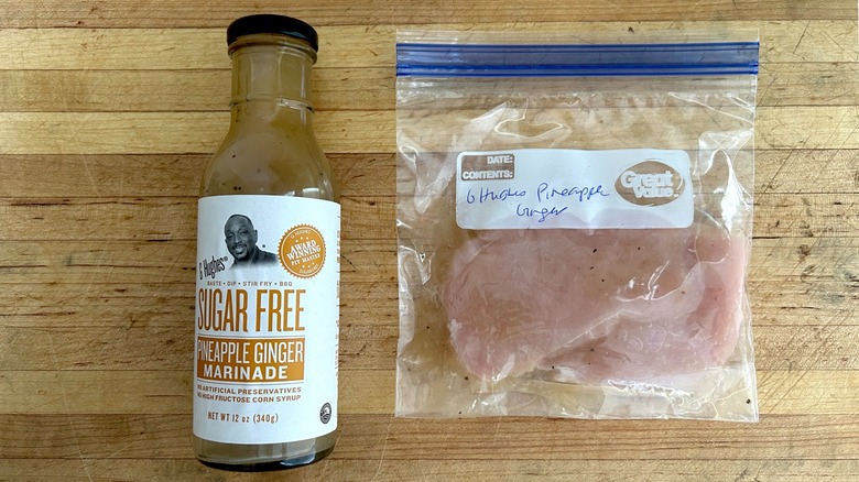 Bottle of G Hughes Sugar Free Pineapple Ginger Marinade and bag with chicken marinating
