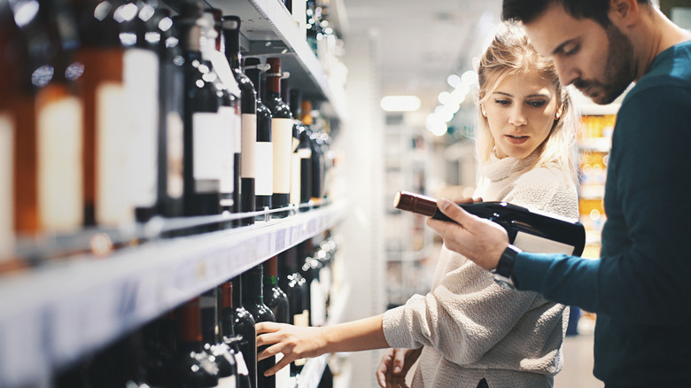 couple choosing bottle of wine