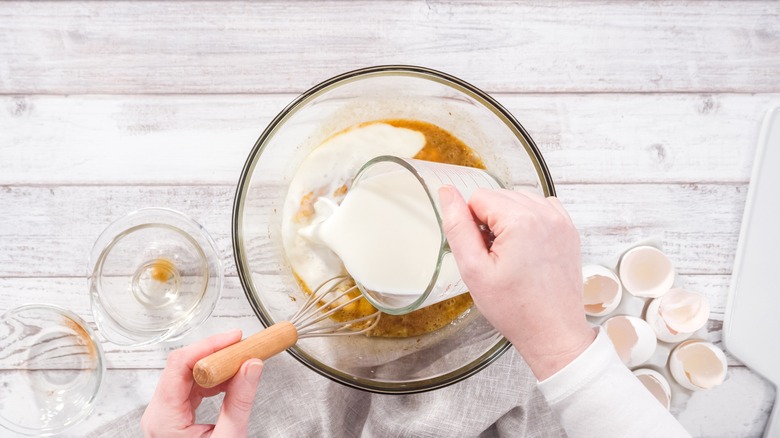 person making french toast custard
