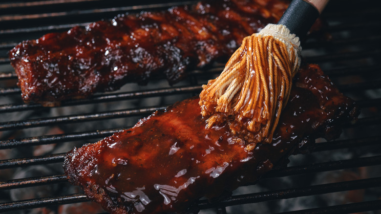 Sauce being daubed onto ribs