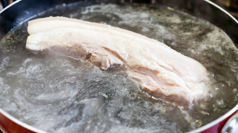 Pork rib in boiling pot of water