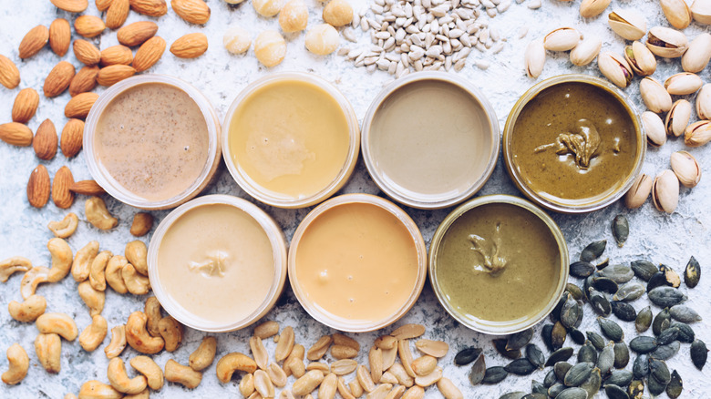 unlidded jars containing various nut butters