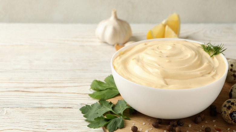 Bowl of mayonnaise on table