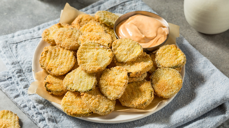 Plate of fried pickles with spicy mayo sauce