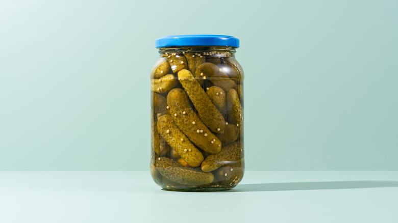 Jar of pickles on a blue background