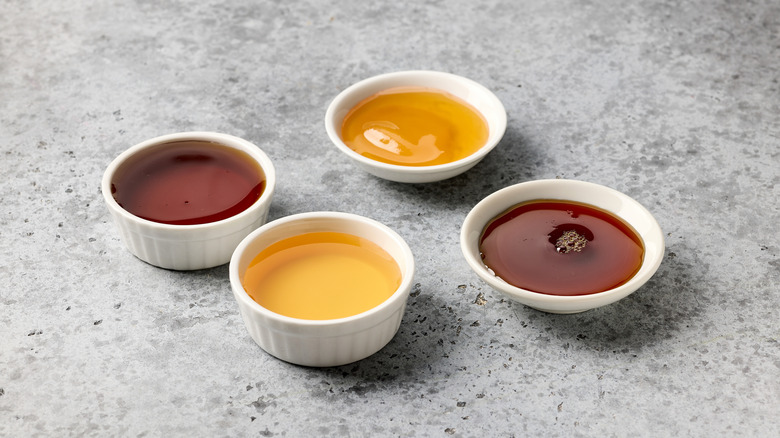 Small white ceramic ramekins filled with various natural sweeteners