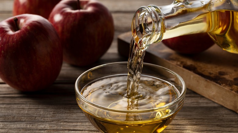 Pouring apple cider in bowl