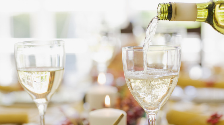 Pouring wine into glasses