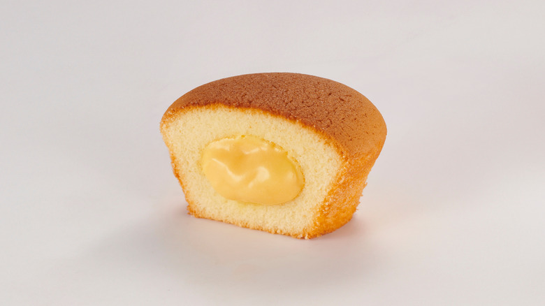 Uniced cupcake cut in half to reveal a creamy filling