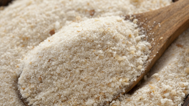 Breadcrumbs on a wooden spoon and in a bowl