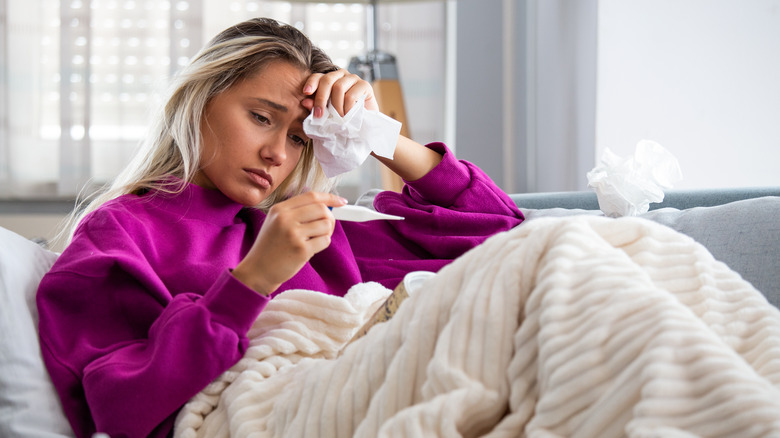 woman sick on couch