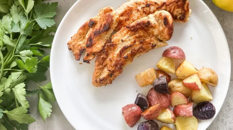 plate of roasted potatoes and chicken, parsley