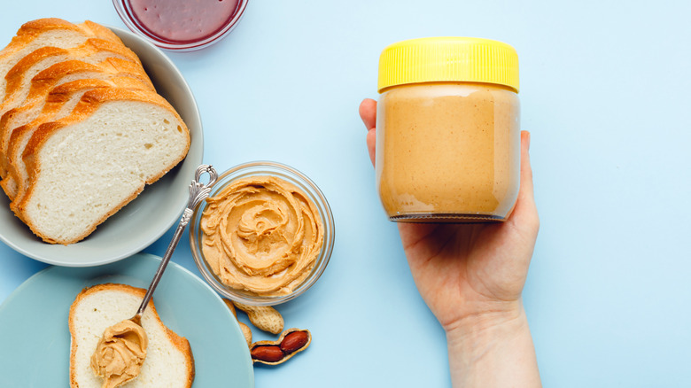 person holding peanut butter jar
