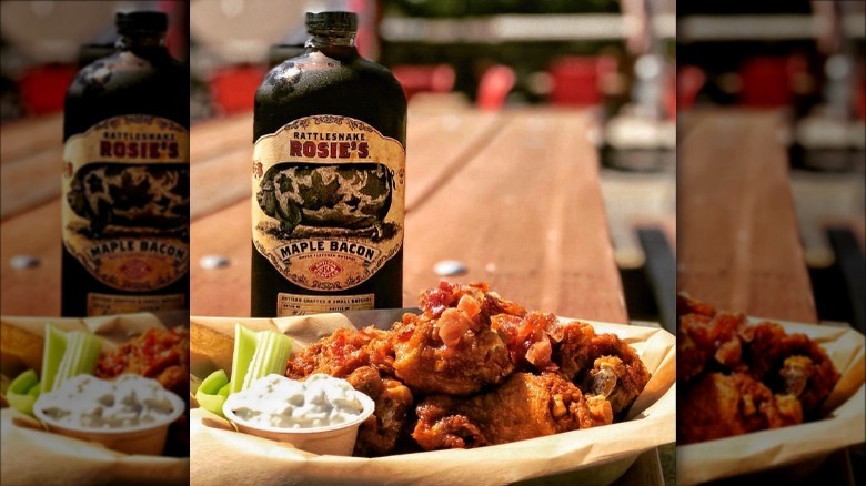 Bottle of whiskey behind wings