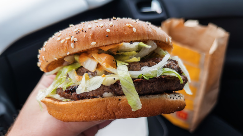 Person holding McDonald's hamburger